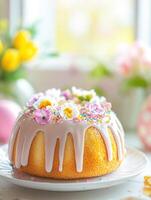 Beautifully decorated Easter cake with flowers and icing drizzle in a spring setting photo