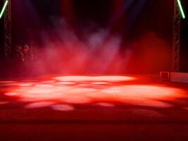 Empty stage with red lights and smoke effects in theater setting photo