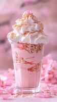 Sakura flavored parfait in tall glass with whipped cream and cherry blossoms photo