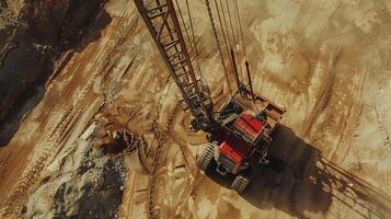 A large excavator is positioned at a construction site, with tire tracks and earth visible around. Workers are preparing for upcoming construction activities under clear blue skies. photo