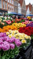 A lively spring market in Bruges Belgium with flower stalls fresh produce and colorful umbrellas set against a backdrop of medieval buildings photo