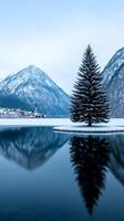 A quiet Christmas night in Hallstatt Austria with snow covered houses reflecting on the frozen lake and a single Christmas tree glowing in the town square photo
