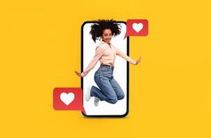 A person joyfully jumps inside a smartphone, surrounded by heart symbols representing excitement in digital communication and social media interactions related to love and dating. photo