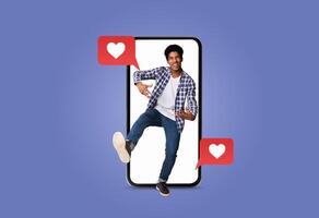 A young person is joyfully interacting with a smartphone showing text messages with heart symbols. This captures the essence of modern dating and social media communication. photo