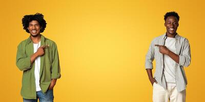 Check This. Two Cheerful African American Guys Pointing In The Middle On Beige Studio Background, Happy Black Male Friends Demonstrating Free Copy Space For Design Or Advertisement, Panorama photo