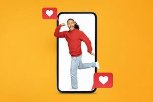 A joyful man in a red sweater jumps out of a large smartphone, celebrating love and connection. Heart icons and messages surround him, highlighting a dating app or Valentine's theme. photo
