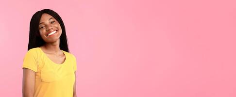 Cheerful Black Woman With Braided Cornrows Hairstyle Smiling To Camera Posing Standing Over Blue Background. Studio Portrait Of Pretty African American Young Lady With Toothy Smile Concept photo