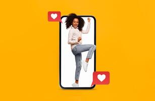 A joyful person is seen inside a smartphone, expressing happiness and excitement. The setting highlights themes of love and connection, perfect for Valentine's Day. photo