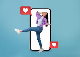 A young person joyfully interacts with a smartphone, surrounded by text messages featuring heart symbols. The playful collage highlights modern dating and communication through apps. photo