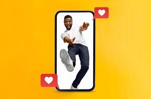 A joyful person interacts with their smartphone, expressing love and excitement. The yellow background highlights themes of social media, connection, and modern technology. photo