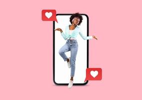 A joyful person poses with a smartphone, engaging in social media and sending heartfelt messages. This stylish image reflects modern romance and connection in a playful, vibrant setting. photo