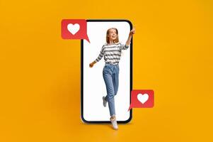 A young person joyfully interacts with a smartphone, expressing excitement through messages and love icons. This portrays the vibrant connection of technology and dating in modern communication. photo