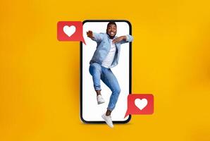 A person joyfully interacts with a smartphone, celebrating connections and messages. Bright yellow background enhances the lively mood of modern dating and social media interactions. photo