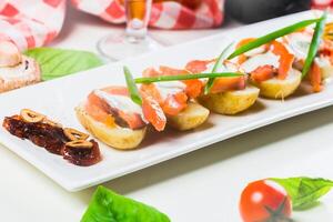 Delicious appetizer featuring smoked salmon and fresh vegetables served in a cozy dining setting photo