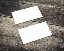 Blank business cards placed on a rustic wooden table ready for design and personalization photo
