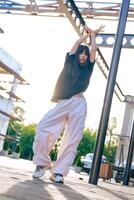 Dance performance under late afternoon light in an urban setting with a stylish outfit photo