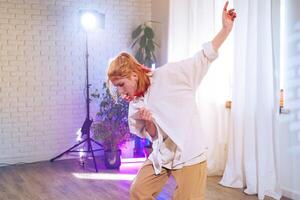 Dance performance by a young woman in a bright studio with natural light and colorful ambiance photo