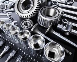 Collection of metal tools arranged neatly on a workbench in a mechanical workshop during daylight hours photo