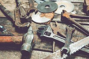 Collection of vintage tools arranged on a rustic wooden surface highlighting craftsmanship and utility photo