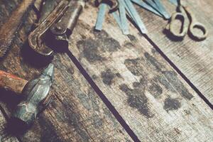 Rustic workshop tools arranged on a wooden bench showcase craftsmanship and creativity in a working space photo