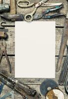 Collection of vintage tools on a rustic wooden table with a blank space for customization photo
