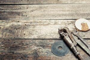 Vintage tools arranged on a rustic wooden workbench in a workshop setting, showcasing craftsmanship and mechanical skill photo