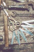 Vintage tools and measuring instruments arranged on a rustic wooden surface in a workshop environment photo