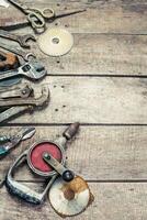Vintage tools arranged on a weathered wooden surface in a rustic workshop setting photo