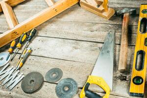 Collection of various woodworking tools and equipment on a rustic wooden workbench photo