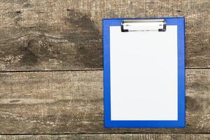 Blank clipboard resting on wooden surface ready for notes and important information collection photo