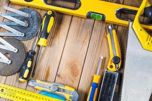 Work tools arranged on a wooden surface for home improvement and DIY projects photo