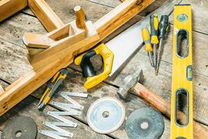 Tools arranged on a wooden surface for woodworking project preparation in a workshop setting photo