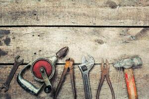 Vintage assortment of hand tools arranged on a rustic wooden surface showcasing their unique features photo