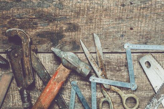 Craftsman tools arranged on a rustic wooden surface in an artisan workshop showing creative potential and craftsmanship photo