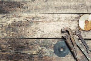 Rustic wooden surface with vintage tools scattered across, perfect for a DIY project setting photo