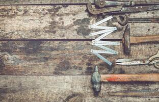 Vintage hand tools arranged on a wooden workbench showcasing craftsmanship and tool maintenance in a rustic environment photo