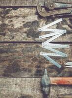 Vintage tools arranged on a rustic wooden surface showcasing craftsmanship and manual work photo