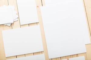 Blank sheets of paper arranged neatly on a wooden surface for creative projects or artistic endeavors photo