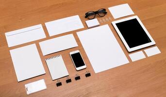Workspace arrangement with stationery, digital devices, and blank materials for creative projects and organization photo