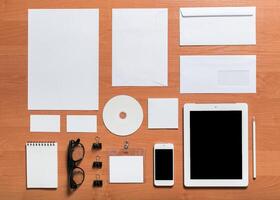 Office supplies and digital tools arranged on a wooden desk during a creative work session photo