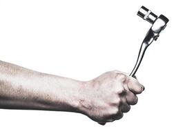 Strong hand gripping a tool in preparation for a mechanical task in a workshop setting photo