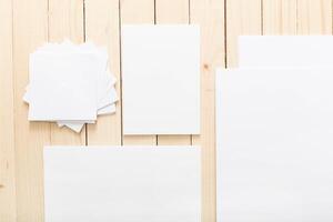 Assorted sheets of blank paper arranged on a wooden surface for creative projects photo