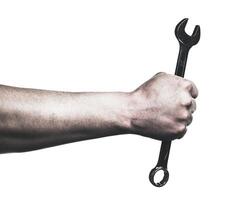 Hand gripping a wrench ready for mechanical work on a machine photo