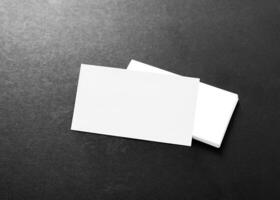 Blank business cards stacked neatly on a dark background creating a minimalistic and professional appearance photo