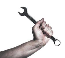 Hand gripping a shiny wrench in a workshop setting, showcasing the strength and skill of a mechanic at work on a project photo