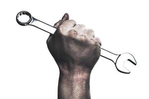 Strong hand gripping a wrench symbolizes determination and craftsmanship in a workshop environment photo