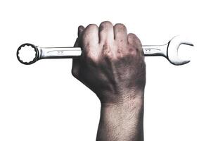 Holding a wrench firmly in hand while preparing for mechanical repairs at a workshop photo