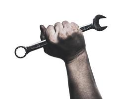 Skilled hand gripping a wrench, showcasing strength and determination during a repair task photo