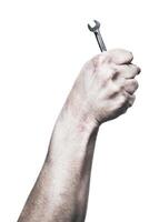 Hand gripping a wrench with determination in a bright setting showcasing tools in action photo