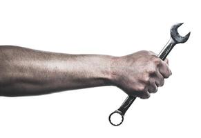 Hand gripping a wrench, showcasing strength and precision in mechanical work environment photo